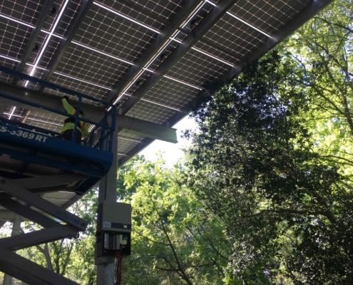 worker installing solar panels