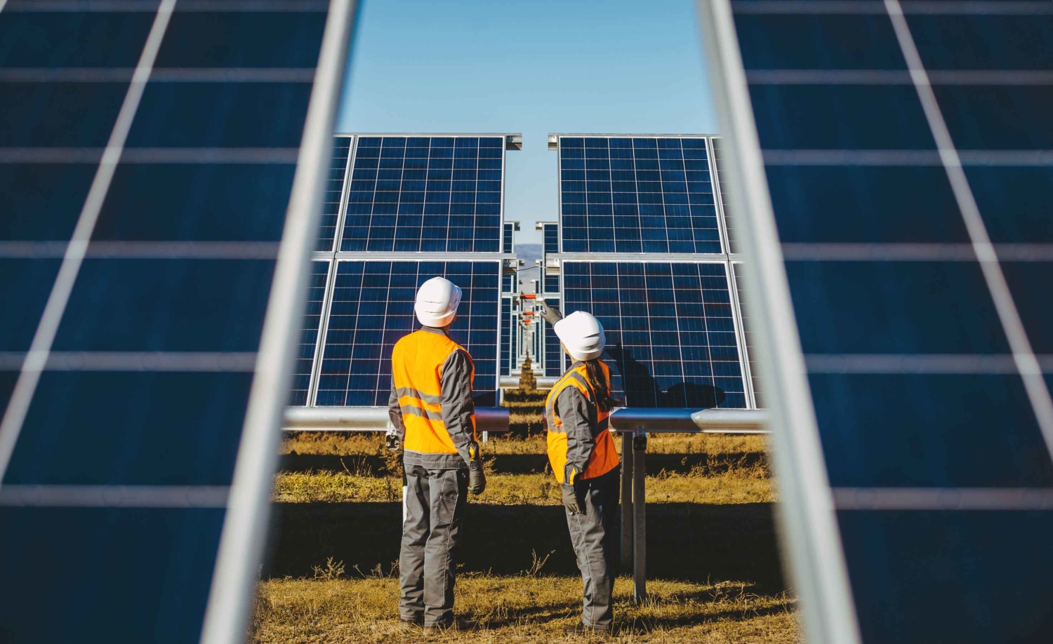 worksers looking at a solar panel